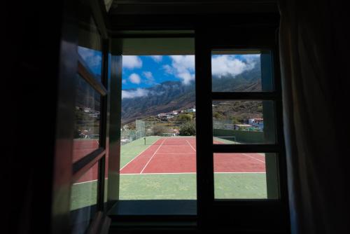 a view of a tennis court through a window at La Brujita in Frontera