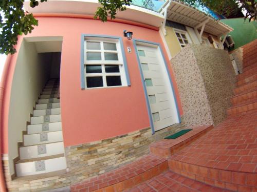 a house with a door and stairs in front of it at Casinhas do Morro in Morro de São Paulo