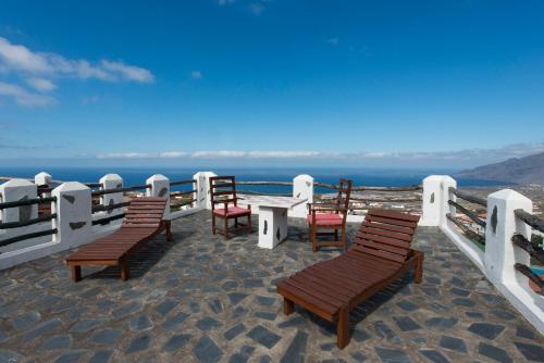 a group of chairs and a table on a balcony at La Brujita in Frontera