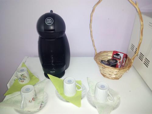 a black coffee maker sitting on a counter next to a basket at Quinta do Quarteiro in Povoação