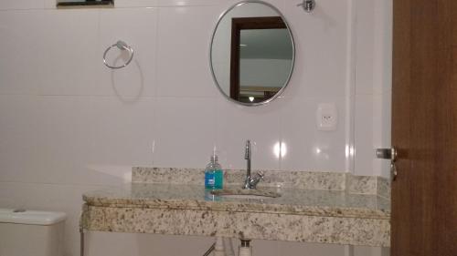 a bathroom with a sink and a mirror at Pousada Recanto do Japa in Nilo Peçanha