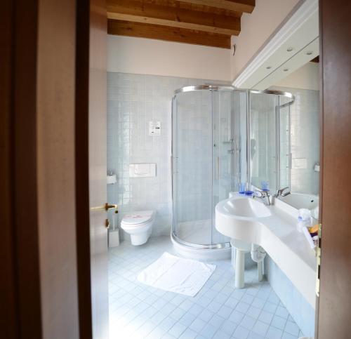 a bathroom with a shower and a sink and a toilet at Hotel Brennero in Bassano del Grappa