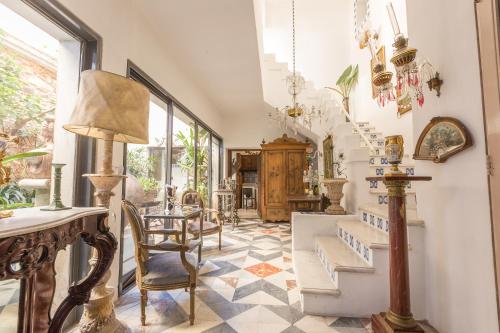 a hallway with a staircase and a table and chairs at Virreinato Hotel Boutique in Cordoba