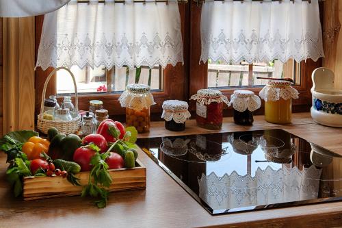 a counter with fruits and vegetables on a window sill at Aleksandrówka - Domek Anastazja in Trześcianka