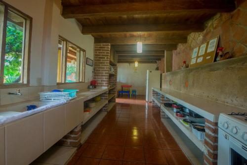 a large kitchen with a stove and a sink at Rossco Hostel & Hotel in San Cristóbal de Las Casas