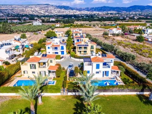 an aerial view of a large house with a swimming pool at Kotsias Corallia Villas in Coral Bay