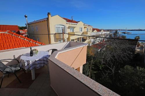 a balcony with a table and a view of the water at Studio Apartments Pavin in Zadar