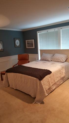 a bedroom with a large bed and a window at Villa Rivarola in Edmonds
