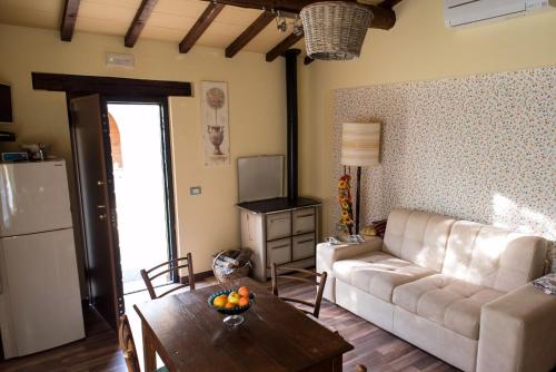 a living room with a couch and a table at Casa la Quiete in Torgiano