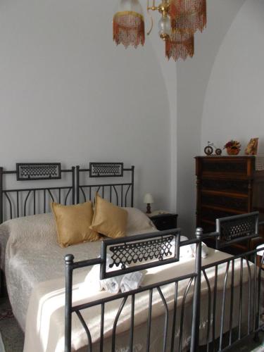 a bedroom with a black bed and a dresser at Casa Nannina in Minori