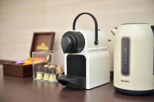 a coffee maker and a toaster sitting on a table at Deak Apartment in Budapest