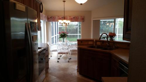 a kitchen with a table and a dining room at Modern Pool Home in Spring Hill