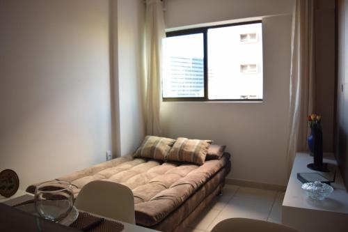 un soggiorno con divano e finestra di Apartamento na Pajuçara a Maceió