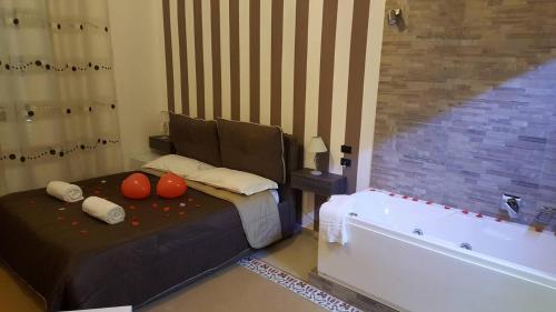 a bedroom with a bed and a bath tub at Alba Camere in Palermo