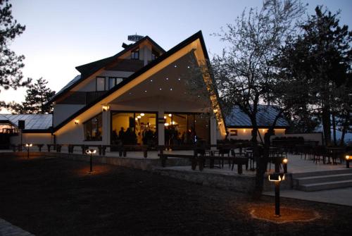 a building with lights in front of it at night at Hotel Trebjesa in Nikšić