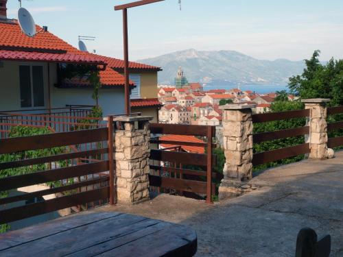 a wooden fence with a view of a city at Apartments Adriatic in Korčula