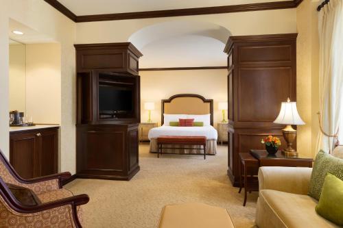 a hotel room with a bed and a couch at Hotel Du Pont in Wilmington
