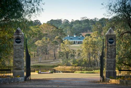 a pair of gates leading to a house at Wandin Valley Estate in Lovedale