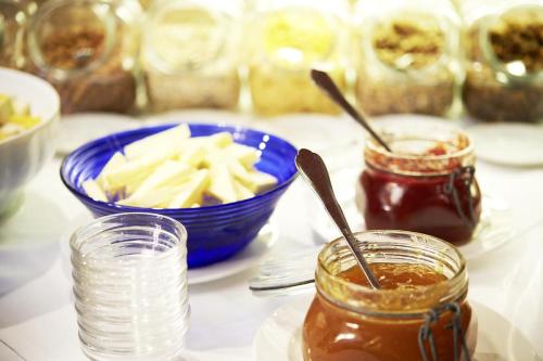 a table with a plate of food and a bowl of food at Hotel Lindner in Vöcklabruck