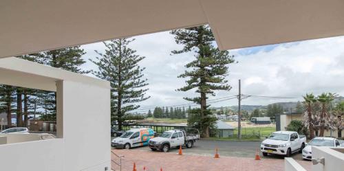 a view of a parking lot with cars parked at Bluewater Apartments in Kiama