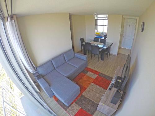 a living room with a couch and a table at Departamento La Serena in La Serena