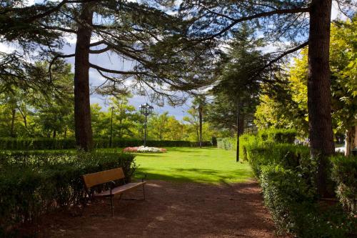 a park bench sitting in the middle of a park at Parador de Teruel in Teruel