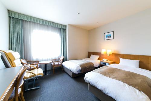 Uma cama ou camas num quarto em Pearl Hotel Ota