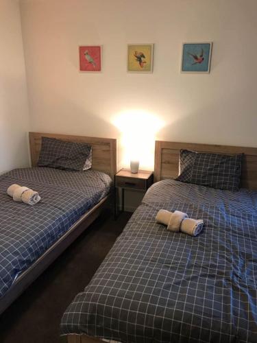 two beds sitting next to each other in a bedroom at Liverpool New Apt 2BR and 2Bath in Liverpool
