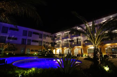 a hotel with a swimming pool at night at Hotel Oazis in Butuan