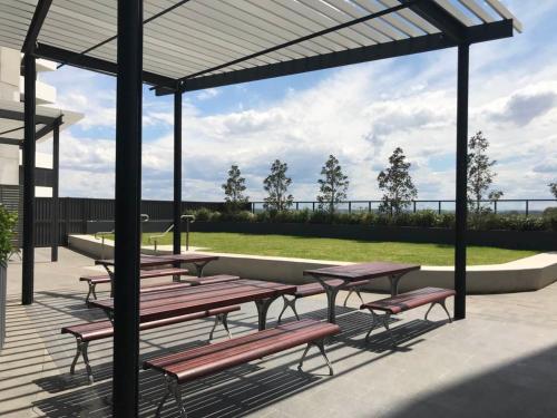 a group of picnic tables and benches under a pavilion at Luxury Apt with 2BR plus 2Bath in Liverpool