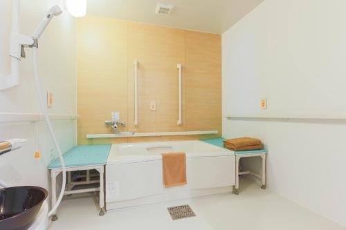 a bathroom with a sink and a mirror at Hotel Higashimokoto in Abashiri