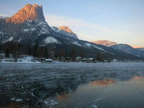 a view of a mountain with a lake in front of it at Apartments Fuchs in Grundlsee