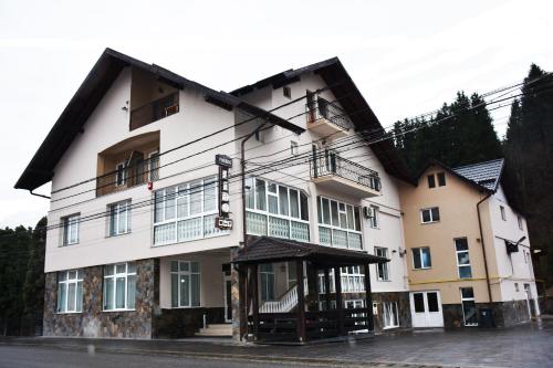 a large white building with a lot of windows at Pensiunea Lido Moisei in Moisei