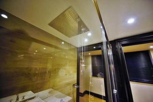 a bathroom with a shower with a sink and a mirror at Nordstern Hotel Galata in Istanbul