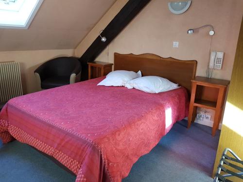 a bedroom with a large bed with a red bedspread at La Bonne Franquette in Villé