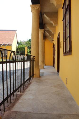 a hallway of a building next to the water at Ciszterci Szállás Pécs in Pécs