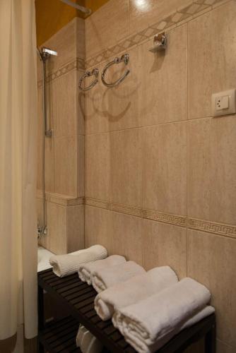 a group of towels on a rack in a bathroom at Santa Ana B&B in Darnius