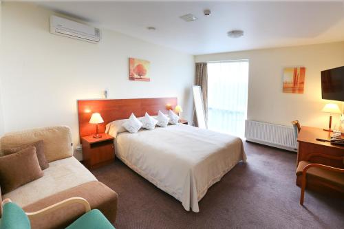 a hotel room with a bed and a couch at Smėlynė in Panevėžys