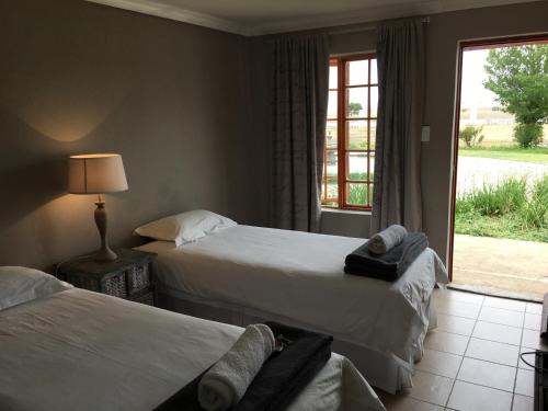 A bed or beds in a room at Rhino Creek Estate