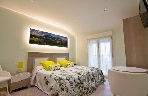 a bedroom with a bed with yellow pillows at Iturritxo Landetxea in Donostia-San Sebastián