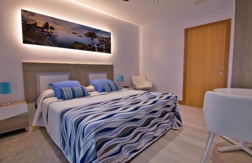 a bedroom with a large bed and a sink at Iturritxo Landetxea in Donostia-San Sebastián