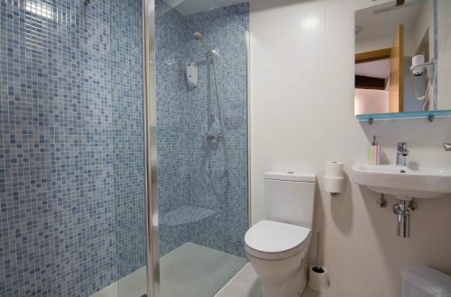 a bathroom with a shower and a toilet and a sink at Iturritxo Landetxea in Donostia-San Sebastián