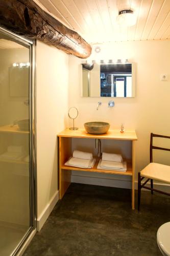 a bathroom with a sink and a shower at Casa Estrela Loft in Juncais