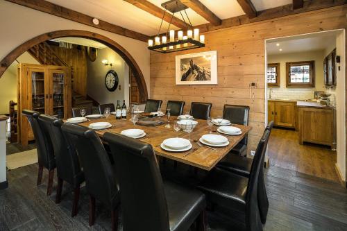 a dining room with a large wooden table and chairs at Chalet Aigle Royal in Chamonix