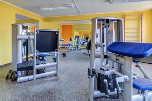 a gym with several tread machines and a tv at Best Western Hotel Vista in Ostrava