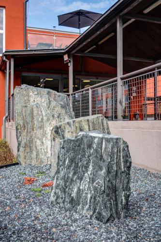 a large rock sitting in front of a building at Best Western Hotel Vista in Ostrava