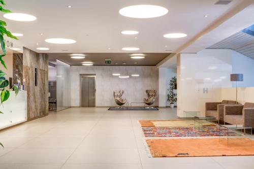 a lobby of a building with a waiting room at Best Western Hotel Vista in Ostrava