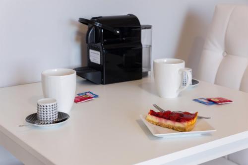 a table with a coffee maker and a plate of food at Residenze Su Planu in Cagliari