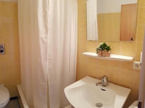 a bathroom with a white shower curtain and a sink at Gasthaus zum Kreuz in Grafenhausen