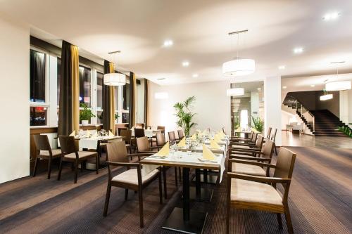 a dining room with long tables and chairs at Congress Hotel Centrum in Košice